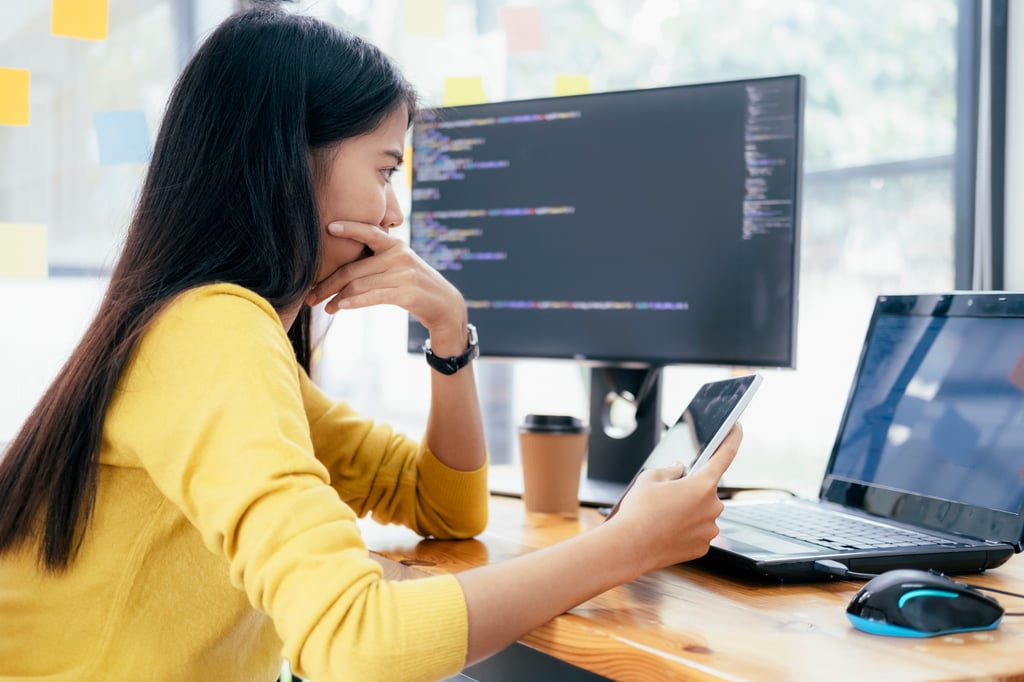 Female cybersecurity consultant analysing DSS compliance data on screen